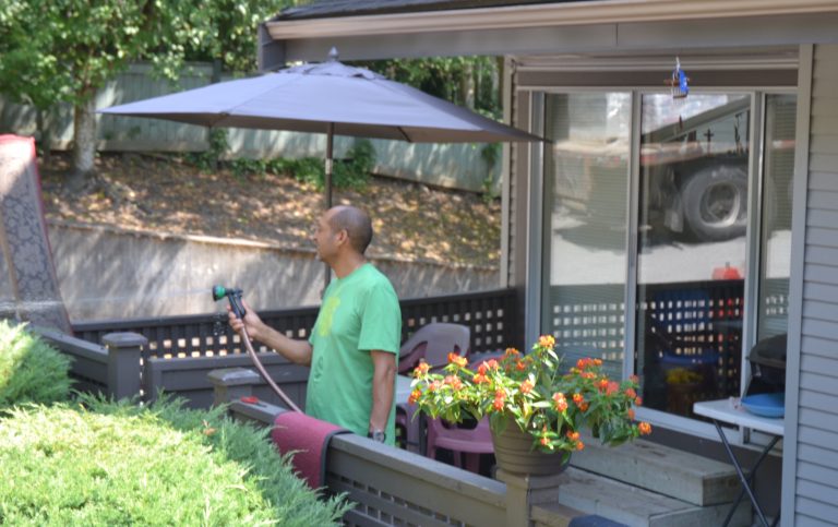 Man watering his garden - Resident of Red Door Housing