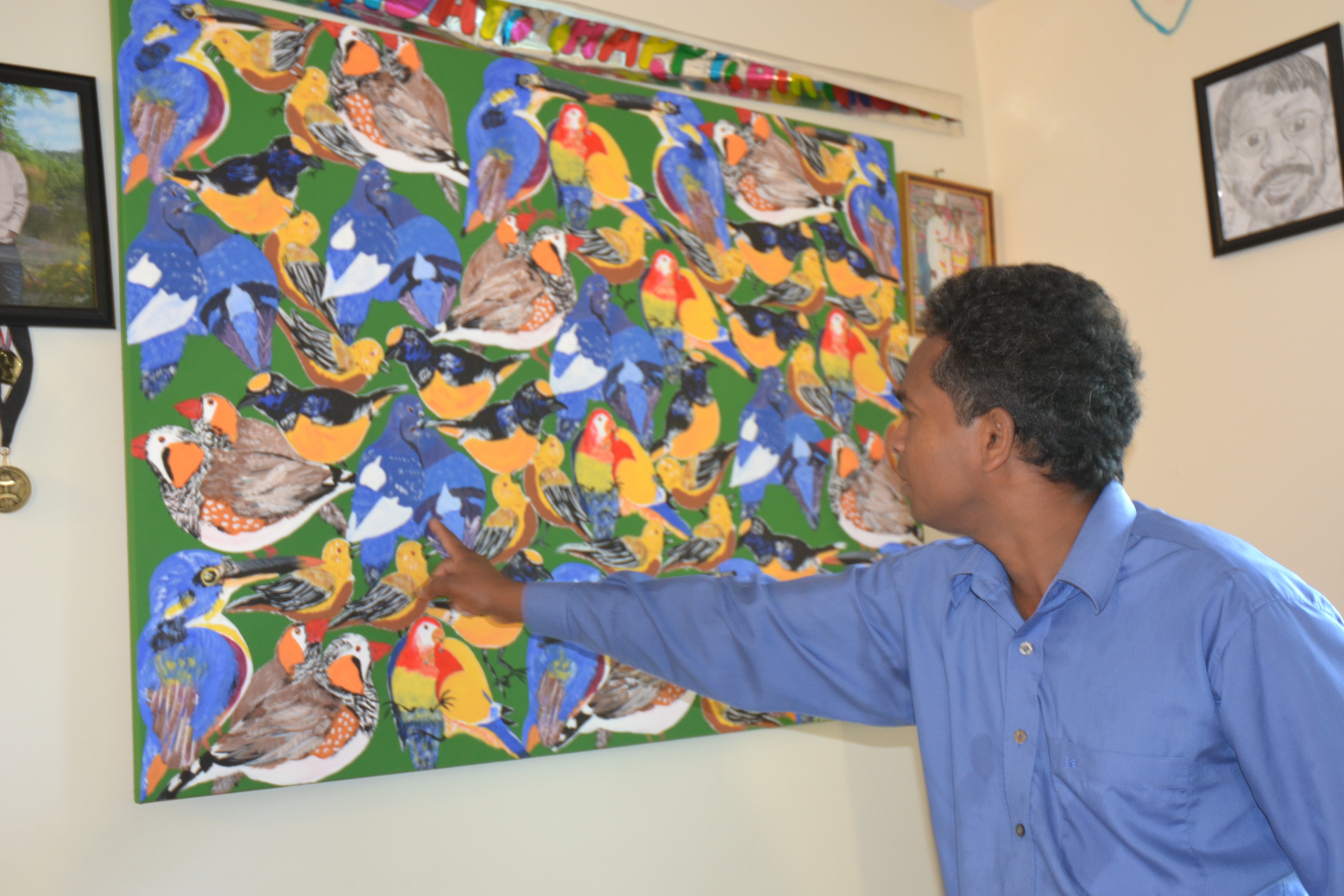 Man showing his painting - Resident of Red Door Housing